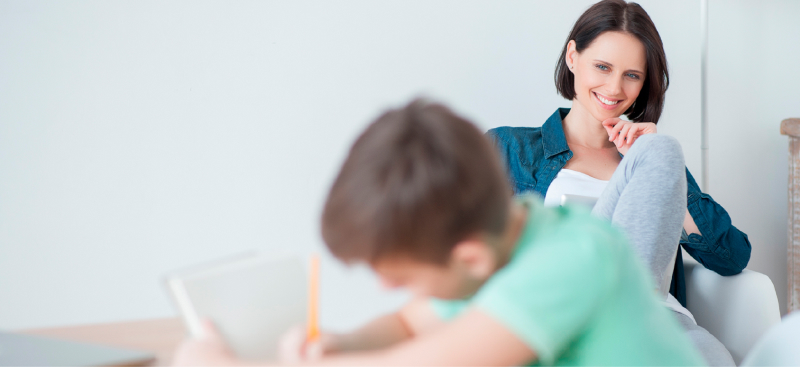 Mother watching son studying