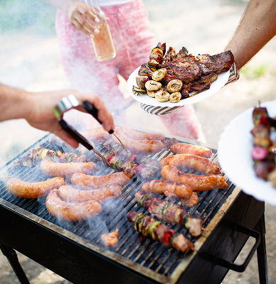 People standing around a barbecue